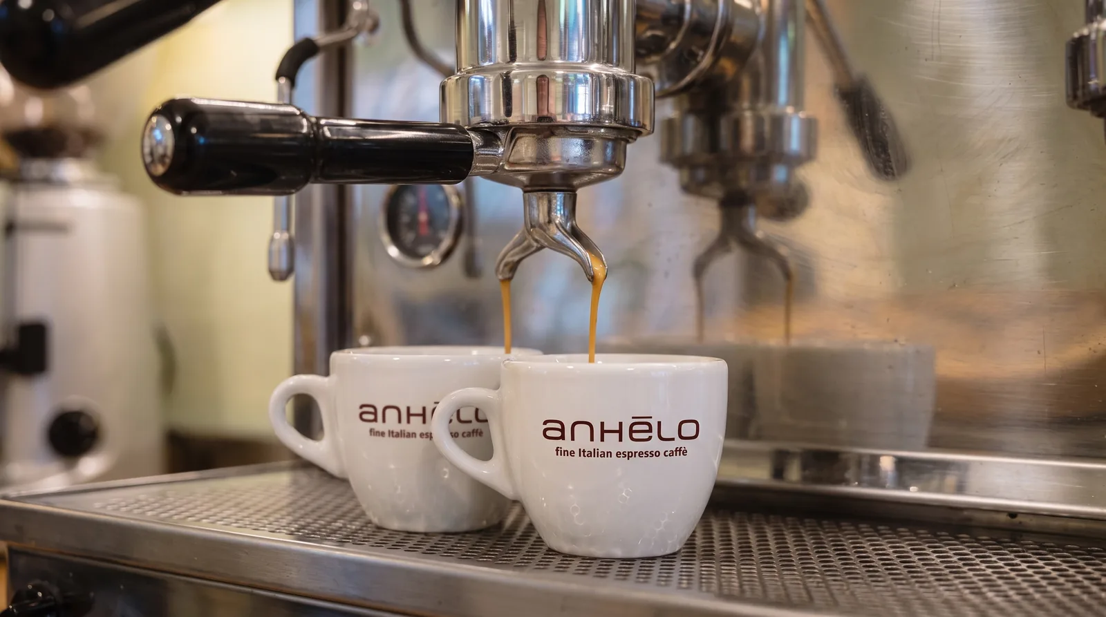 Two Anhelo cups under the group head of a lever machine